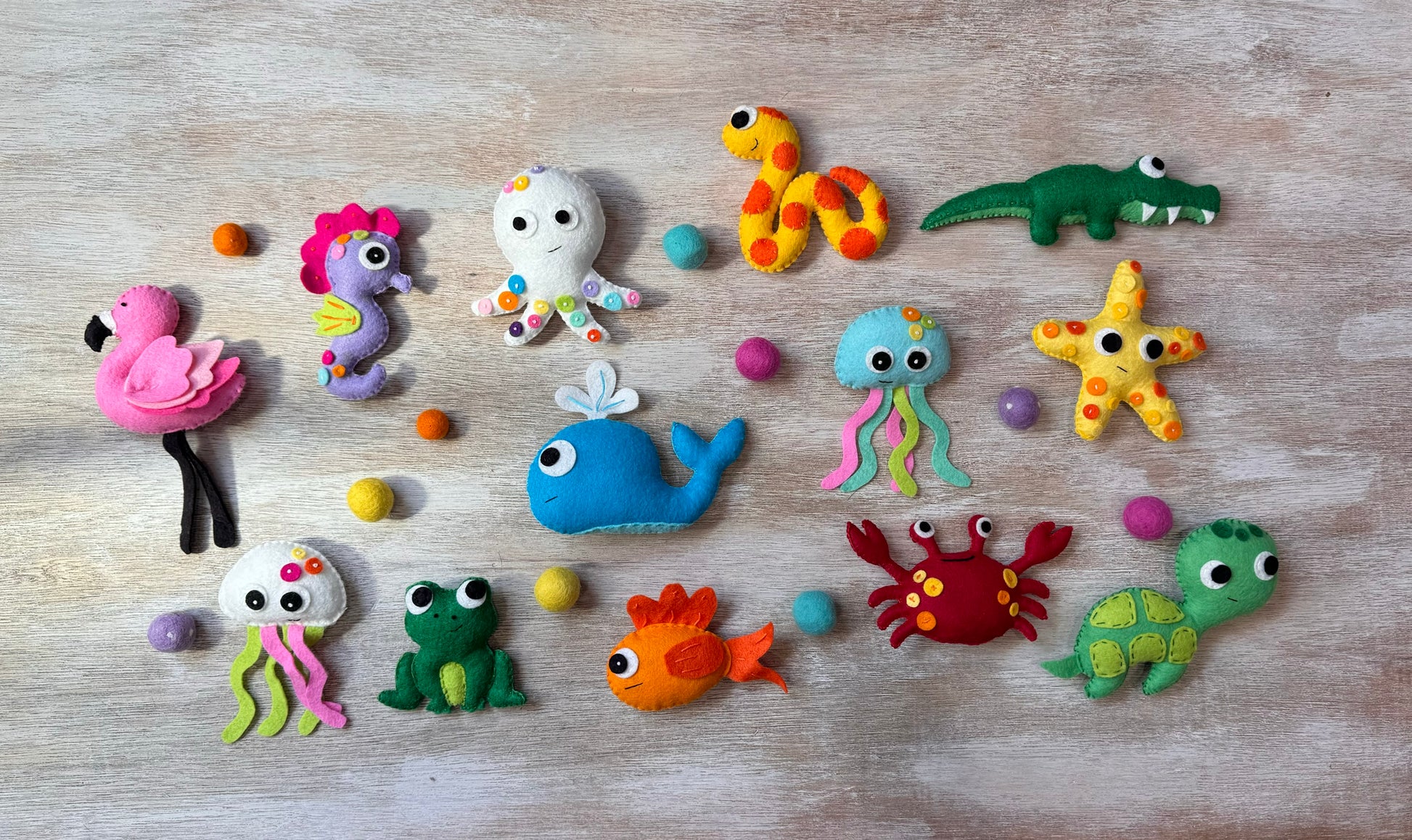 handmade and hand sewn felt creation by a little bit whimsy - brightly colors sea animals/ creatures. primary colors and pastels  snake, octopus, starfish, whale, turtle, crab, nemo fish, frog, seahorse and flamingo.