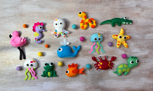 handmade and hand sewn felt creation by a little bit whimsy - brightly colors sea animals/ creatures. primary colors and pastels  snake, octopus, starfish, whale, turtle, crab, nemo fish, frog, seahorse and flamingo.