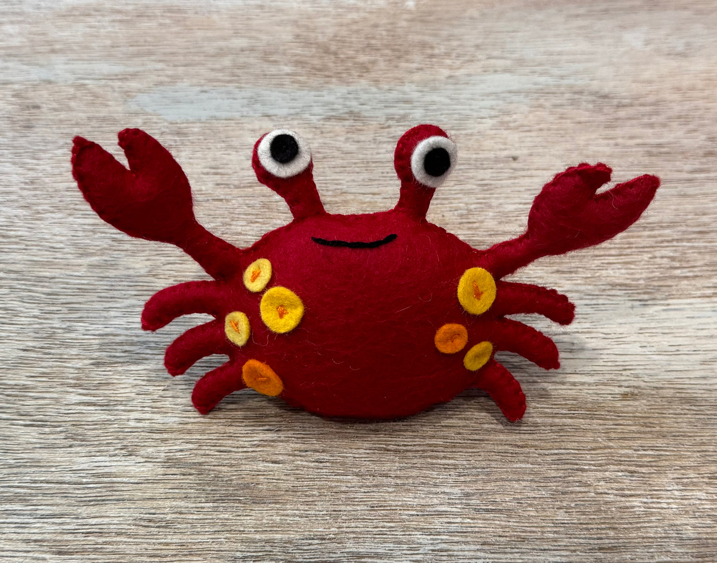 handmade and hand sewn felt creation by a little bit whimsy - brightly colors sea animals/ creatures. primary colors and pastels  smilng red and orange crab