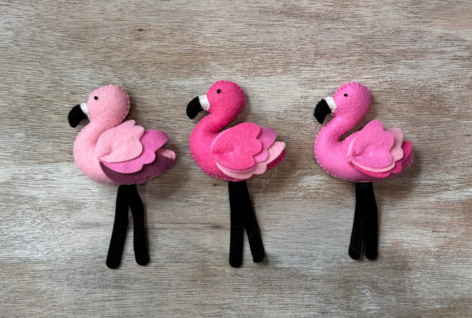 handmade and hand sewn felt creation by a little bit whimsy - brightly colors sea animals/ creatures. primary colors and pastels . 3 smiling pink flamingos
