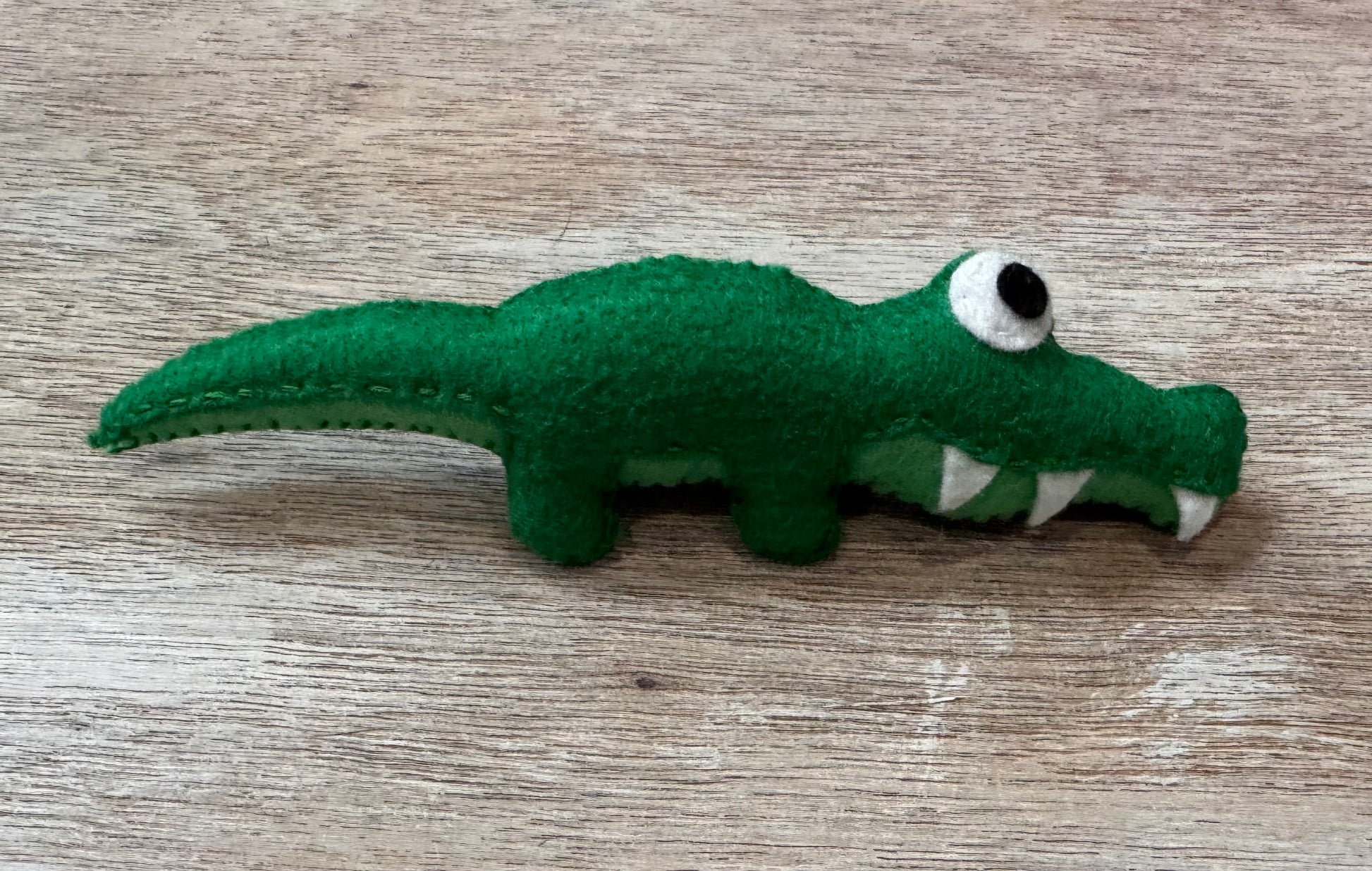 handmade and hand sewn felt creation by a little bit whimsy - brightly colors sea animals/ creatures. primary colors and pastels  smiling green alligator
