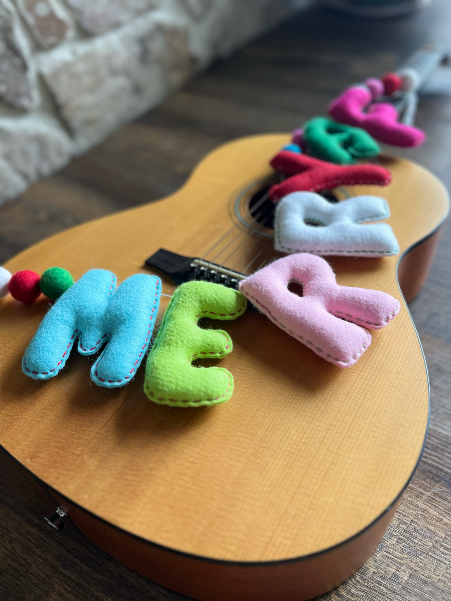 Merry spelled out in hand stitched felt letters