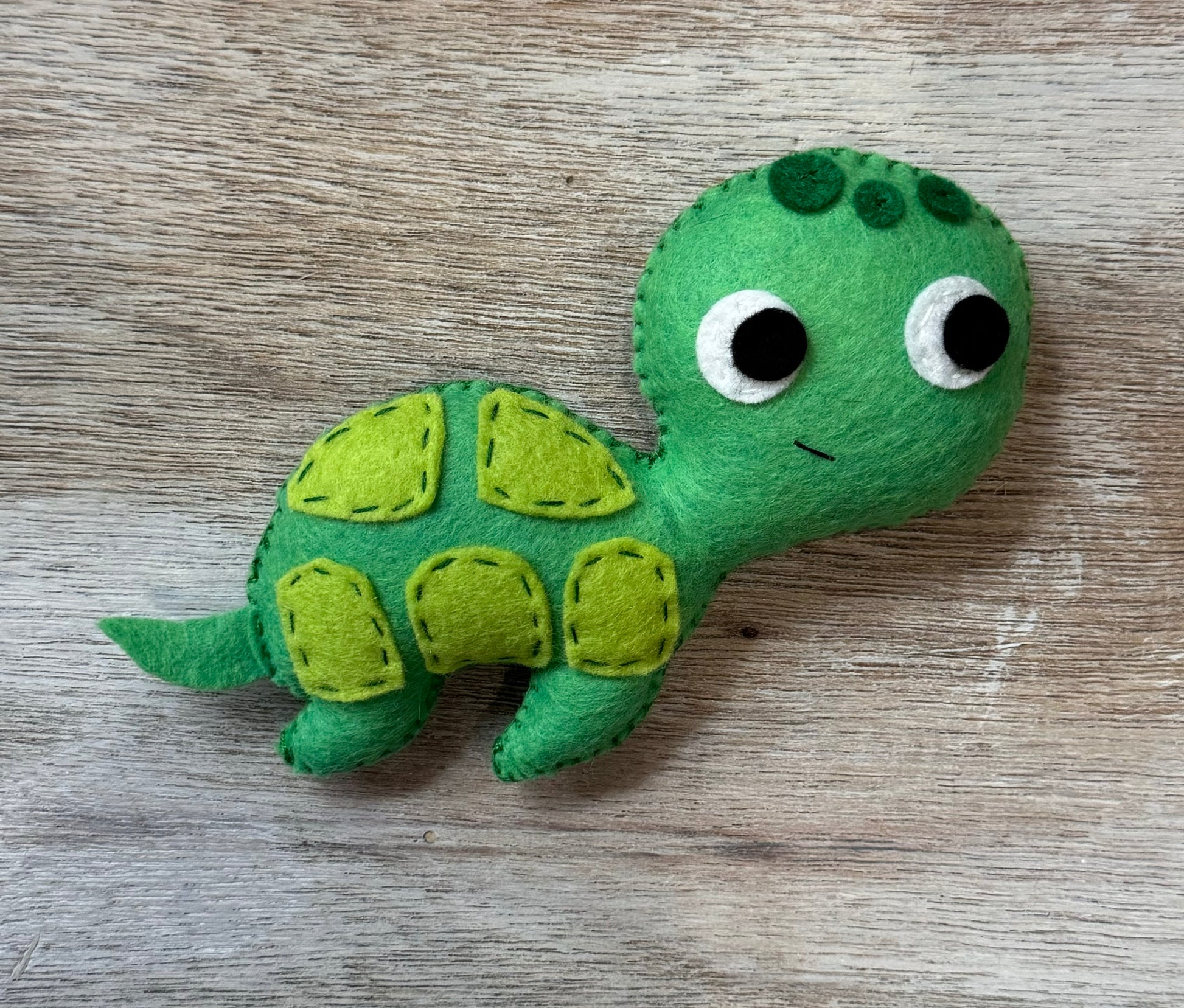 handmade and hand sewn felt creation by a little bit whimsy - brightly colors sea animals/ creatures. primary colors and pastels  cute smiling green turtle