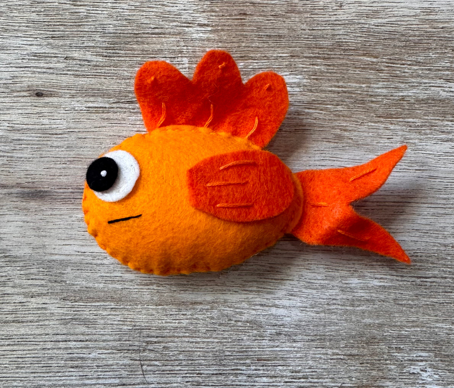handmade and hand sewn felt creation by a little bit whimsy - brightly colors sea animals/ creatures. primary colors and pastels  smiling orange fish