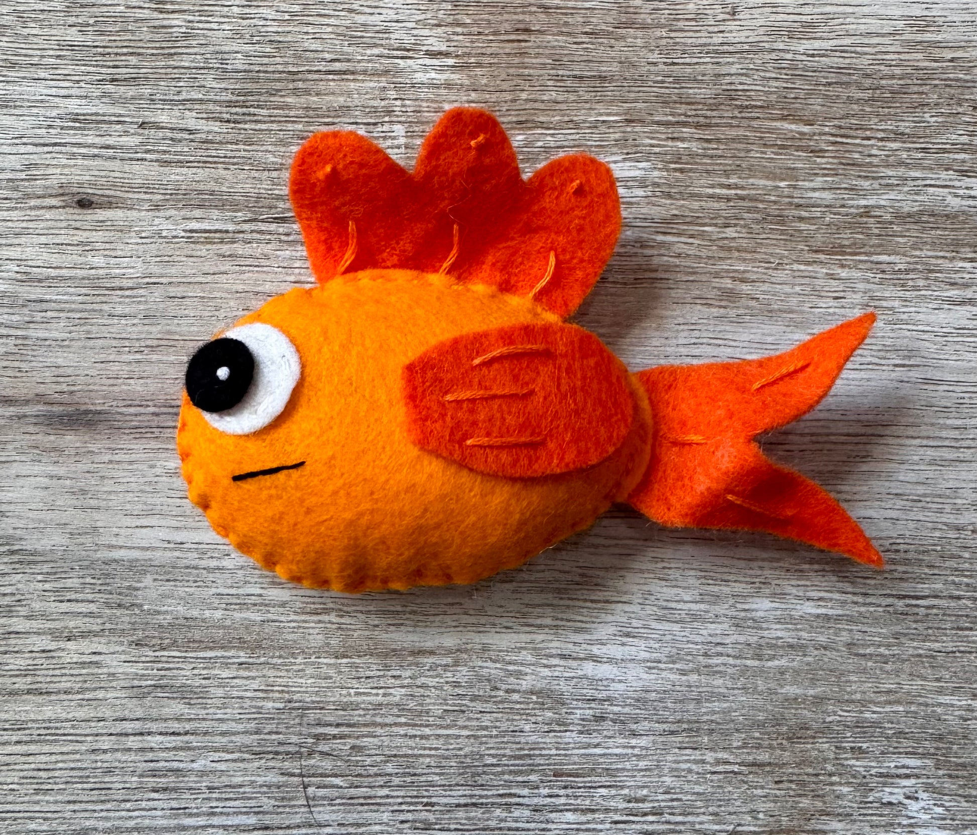 handmade and hand sewn felt creation by a little bit whimsy - brightly colors sea animals/ creatures. primary colors and pastels  smiling orange fish