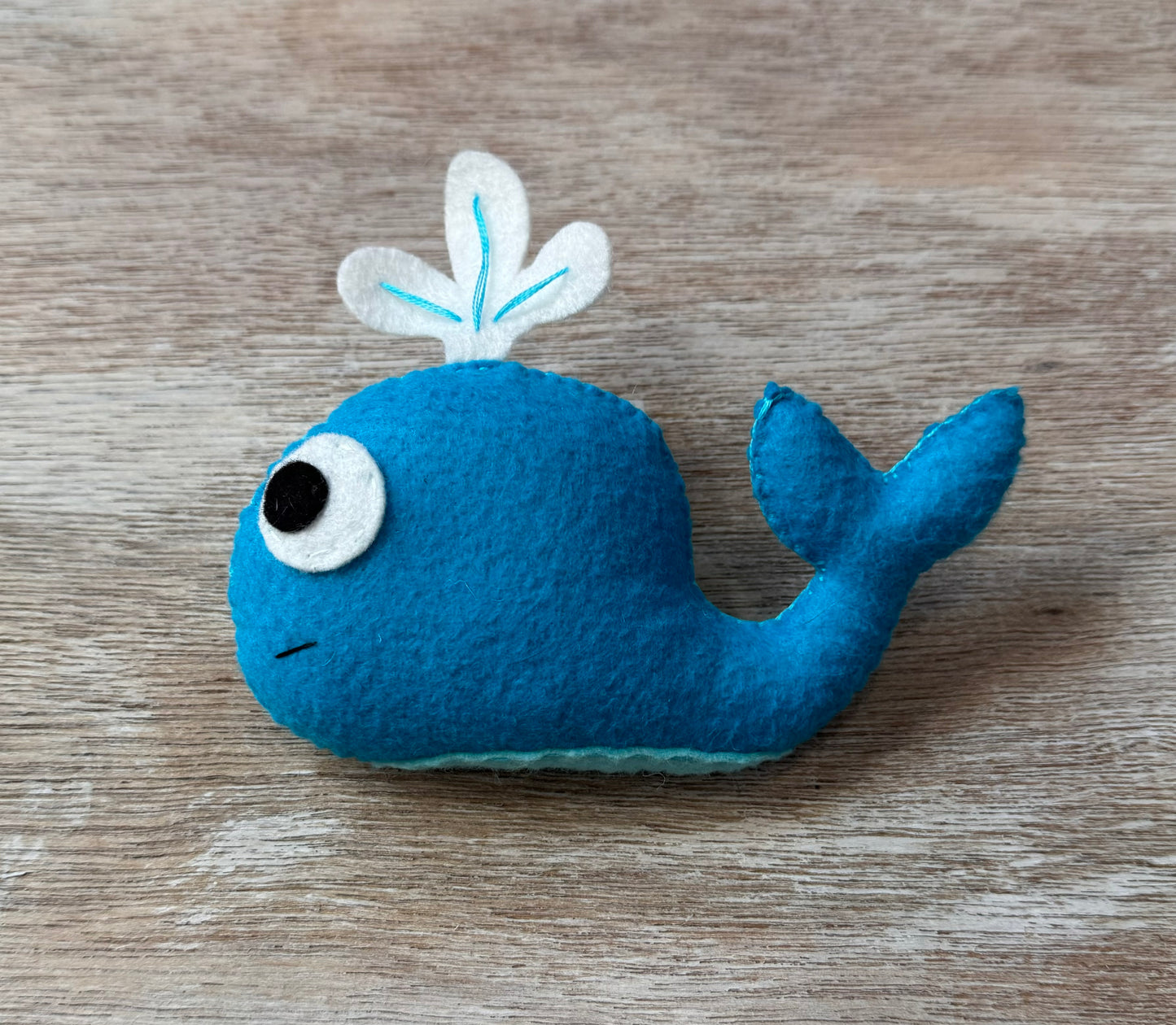 handmade and hand sewn felt creation by a little bit whimsy - brightly colors sea animals/ creatures. primary colors and pastels  smiling blue whale