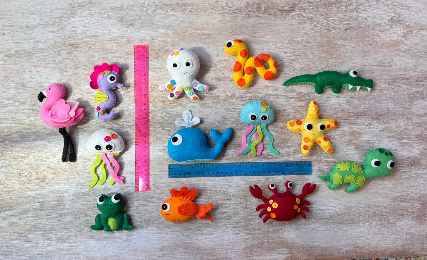 handmade and hand sewn felt creation by a little bit whimsy - brightly colors sea animals/ creatures. primary colors and pastels  snake, octopus, starfish, whale, turtle, crab, nemo fish, frog, seahorse and flamingo.