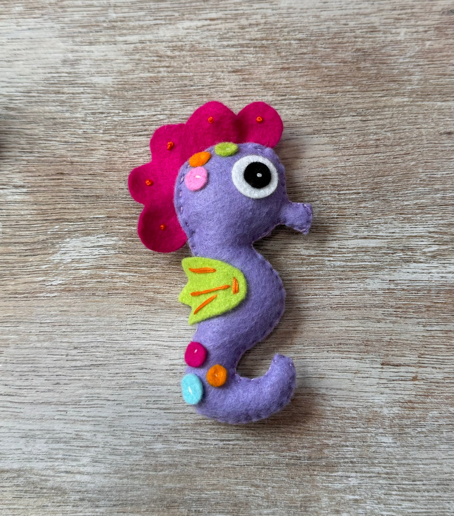 handmade and hand sewn felt creation by a little bit whimsy - brightly colors sea animals/ creatures. primary colors and pastels  smiling purple and pink seahorse