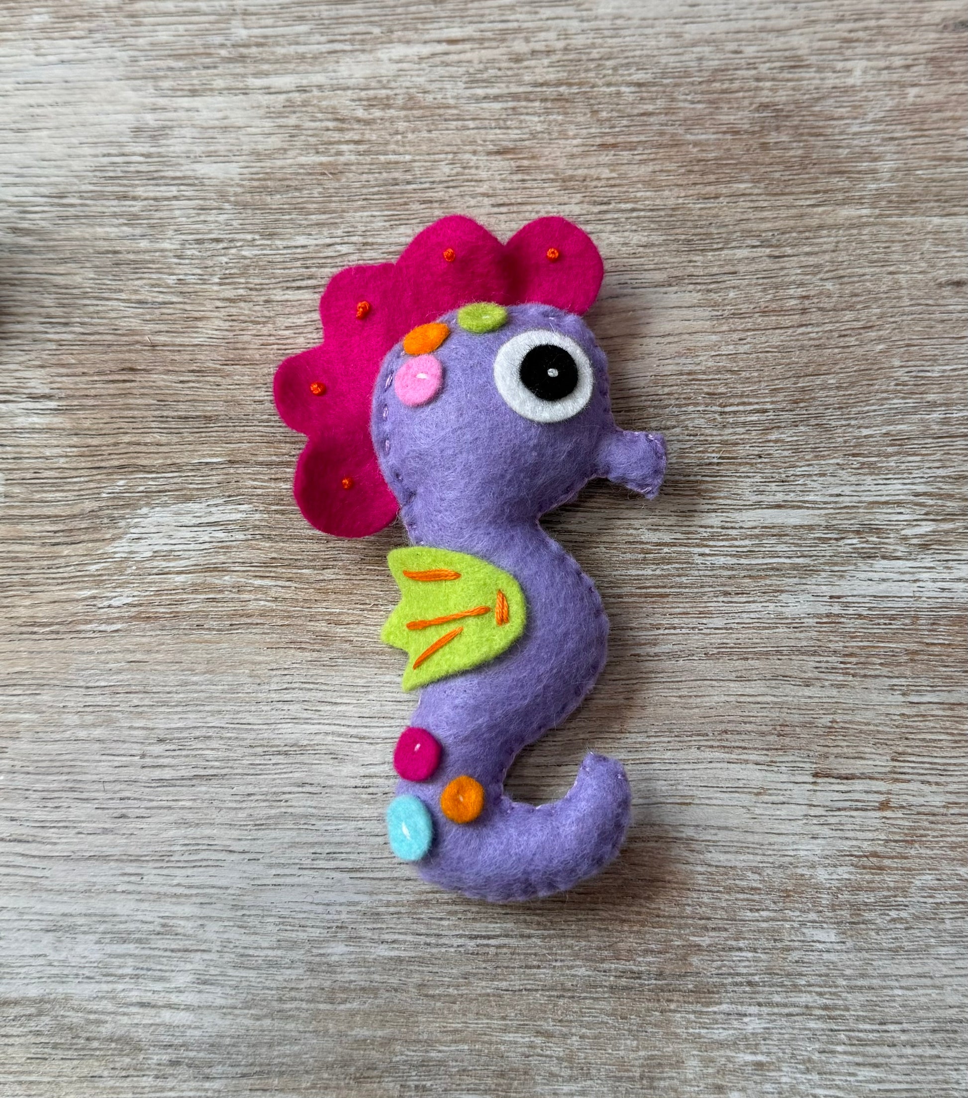 handmade and hand sewn felt creation by a little bit whimsy - brightly colors sea animals/ creatures. primary colors and pastels  smiling purple and pink seahorse